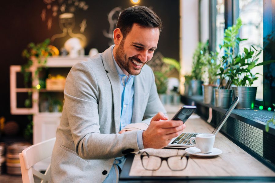 Blog - Business Man Using His Phone To Read a Blog
